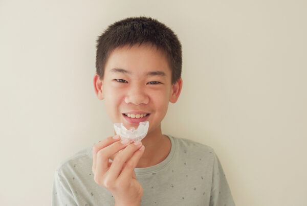 Sports Mouthguards for Kids in Ogden, UT, A kid holding a mouthguard